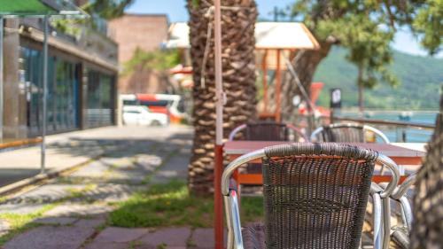 a chair sitting at a table next to a tree at Geoje Break Time Pension in Geoje 