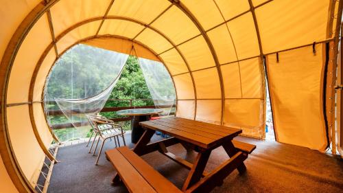 a room with a table in a dome tent at Gapyeong Soopia pension in Gapyeong