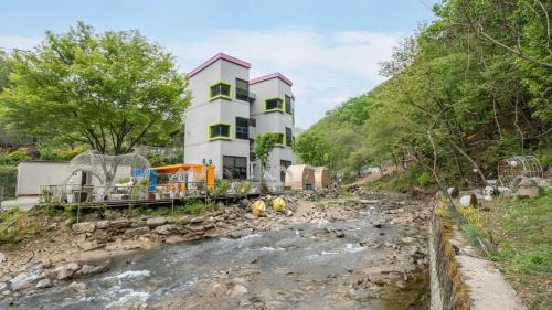 a building on the side of a river at Gapyeong Soopia pension in Gapyeong