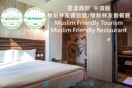 a bedroom with a bed and two plates on the wall at Stay Hotel - Taichung Zhongqing in Taichung