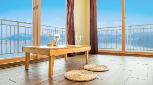 a room with a table and two wine glasses at Daebudo green beach Pension in Ansan