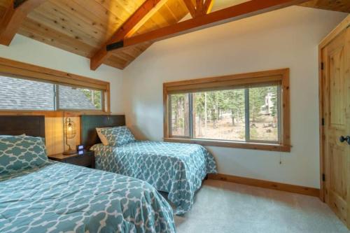 a bedroom with two beds and a window at Henderson by AvantStay Lake View Walk to Beach Garwoods More in Carnelian Bay