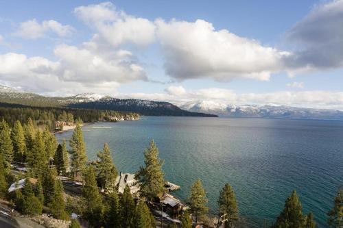 a view of a lake with snow covered mountains at Henderson by AvantStay Lake View Walk to Beach Garwoods More in Carnelian Bay