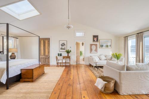 a bedroom with a bed and a living room at River House by AvantStay Historic Secluded Estate on the Hudson River w Pool Sleeps 24 in Hudson