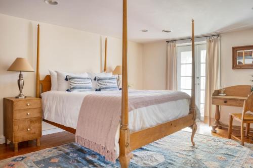 a bedroom with a large bed with a four poster bed sidx sidx sidx at River House by AvantStay Historic Secluded Estate on the Hudson River w Pool Sleeps 24 in Hudson