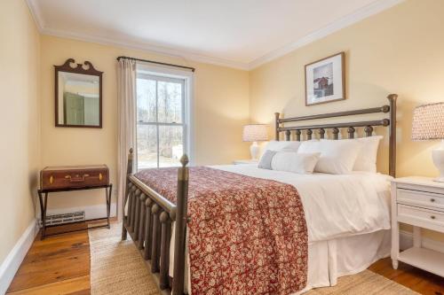 a bedroom with a large bed and a window at River House by AvantStay Historic Secluded Estate on the Hudson River w Pool Sleeps 24 in Hudson