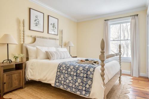 a bedroom with a bed and a window at River House by AvantStay Historic Secluded Estate on the Hudson River w Pool Sleeps 24 in Hudson