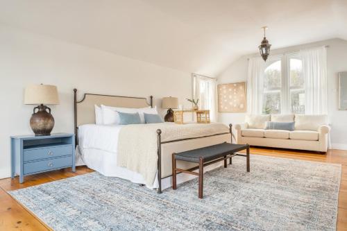 a bedroom with a bed and a couch at River House by AvantStay Historic Secluded Estate on the Hudson River w Pool Sleeps 24 in Hudson