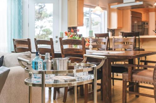 a living room with two tables and chairs at Villa Manzanita by AvantStay Hot Tub 1 Block to BeachTown Chefs Kitchen in Manzanita