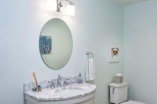a white bathroom with a sink and a mirror at Villa Manzanita by AvantStay Hot Tub 1 Block to BeachTown Chefs Kitchen in Manzanita