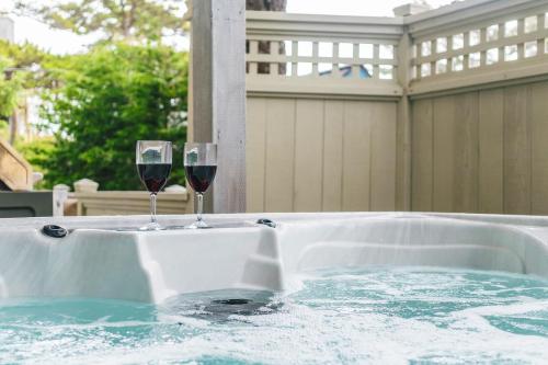 two glasses of wine sitting on a hot tub at Villa Manzanita by AvantStay Hot Tub 1 Block to BeachTown Chefs Kitchen in Manzanita
