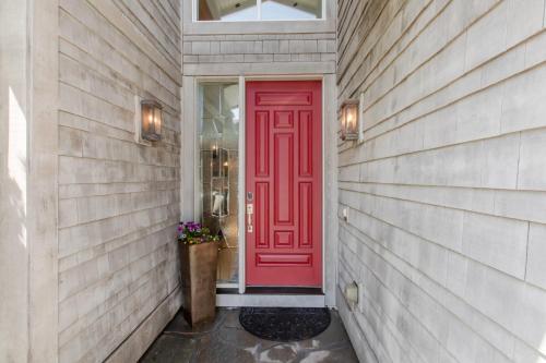 a red door on a house with a window at Villa Manzanita by AvantStay Hot Tub 1 Block to BeachTown Chefs Kitchen in Manzanita