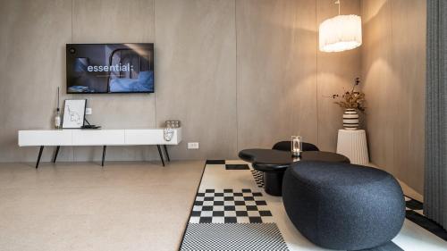 a living room with a blue chair and a tv at Goseong Gyeoulbada Ocean View Pension in Goseong