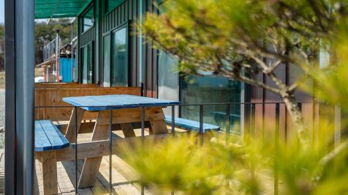 a picnic table on the deck of a building at Gyeongju Jayeon Pension in Gyeongju