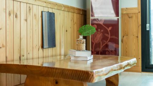 a wooden table with a potted plant on top of it at Gyeongju Jayeon Pension in Gyeongju