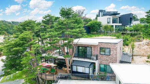 an aerial view of a house with trees at Goseong Pinetree Pension in Goseong
