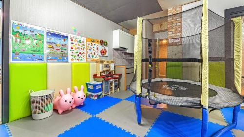 a childs room with a bunk bed and a play room with at Goseong Pinetree Pension in Goseong
