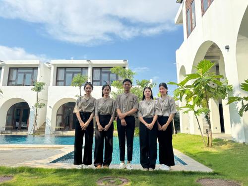 a group of people standing in front of a house at STONE AGE Boutique in Kampot