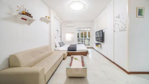 a living room with a couch and a bed at Gapyeong ID pension in Gapyeong