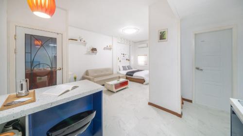 a large white room with a room with a bed at Gapyeong ID pension in Gapyeong