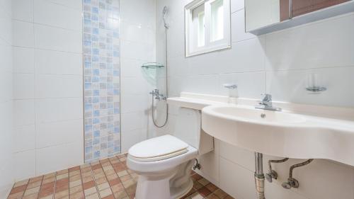 a bathroom with a white toilet and a sink at Gangwha Jeongwon Pension in Incheon
