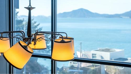 a group of lights hanging in front of a window at Namhae Byeol grigo namhae Pension in Namhae