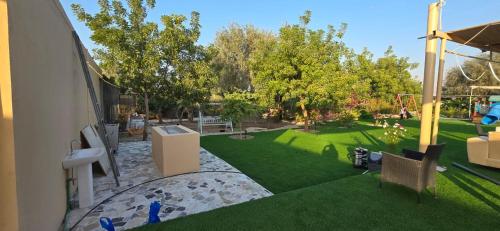 an image of a backyard with a lawn at NMY Farm1 in Ras al Khaimah