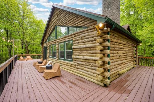 a log cabin with chairs on a wooden deck at Half Moon by AvantStay 4BR Cabin w Large Deck Yard w Patio Outdoor Dining in Great Barrington