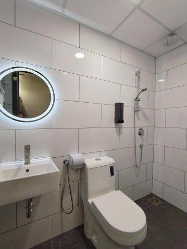 a bathroom with a toilet and a sink and a mirror at The great hotel greenhill in Ipoh