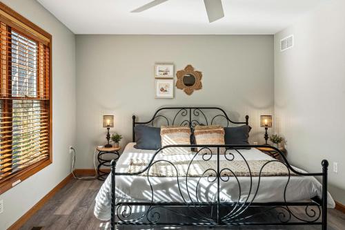 a bedroom with a black metal bed in a room at Lakers Pointe by AvantStay Lakefront Private Peninsula Hot Tub Game Room in Long Pond