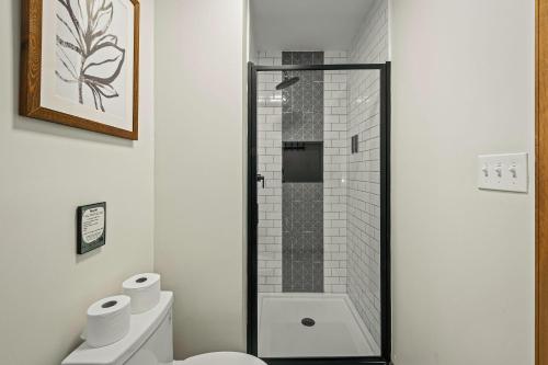 a bathroom with a shower and a toilet at Lakers Pointe by AvantStay Lakefront Private Peninsula Hot Tub Game Room in Long Pond