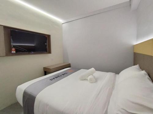 a hotel room with a bed and a television at The great hotel greenhill in Ipoh
