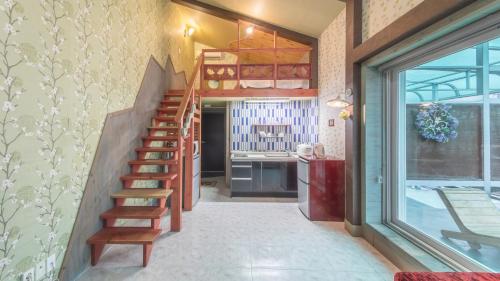 a staircase in a room with a kitchen at Gapyeong Namueuikkum pension in Gapyeong