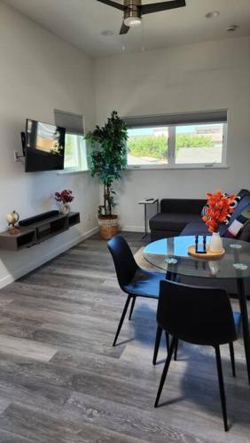 a living room with a table and a tv at Modern Furnished Retreat in Eugene