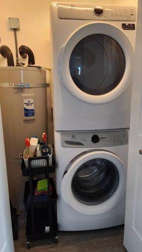 a washing machine is next to a washer at Modern Furnished Retreat in Eugene