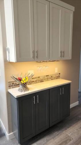 a kitchen with white cabinets and a counter top at Modern Furnished Retreat in Eugene