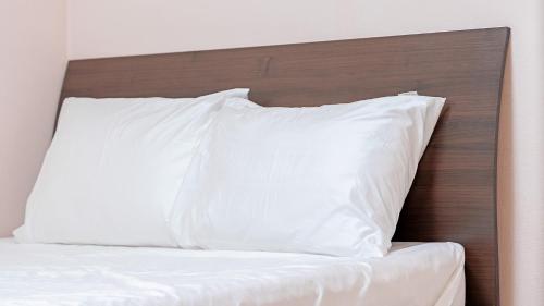 Ένα ή περισσότερα κρεβάτια σε δωμάτιο στο Geoje Youngsu Pension