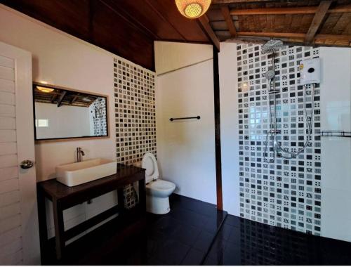 a bathroom with a sink and a toilet and a shower at Mai Pen Rai Bungalows in Than Sadet Beach