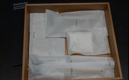 a box filled with white papers in a wooden box at No25 Hotel Naeoe in Gimhae