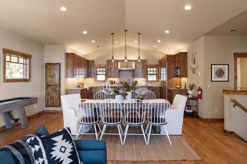 a dining room and kitchen with a table and chairs at Atkinson by AvantStay Lake Front Home w Stunning Views in Tahoe Vista in Tahoe Vista