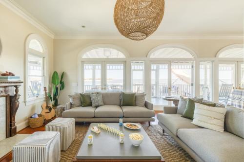 a living room with two couches and a table at Haven by AvantStay Luxury Beachfront Home w Pool Gorgeous Patios in Sullivans Island
