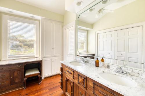 a bathroom with two sinks and a large mirror at Haven by AvantStay Luxury Beachfront Home w Pool Gorgeous Patios in Sullivans Island