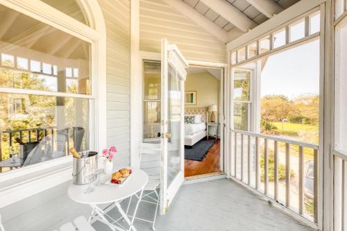 a room with a balcony with a table and a bed at Haven by AvantStay Luxury Beachfront Home w Pool Gorgeous Patios in Sullivans Island