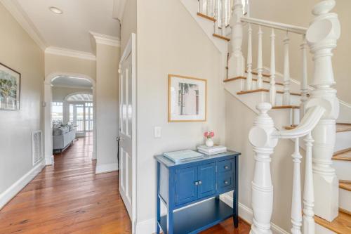 a staircase with a blue cabinet and a blue table at Haven by AvantStay Luxury Beachfront Home w Pool Gorgeous Patios in Sullivans Island