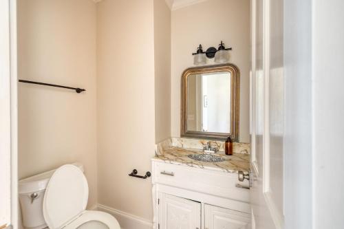 a bathroom with a sink and a mirror and a toilet at Haven by AvantStay Luxury Beachfront Home w Pool Gorgeous Patios in Sullivans Island