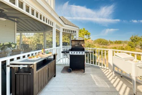 a screened porch with a grill on a house at Haven by AvantStay Luxury Beachfront Home w Pool Gorgeous Patios in Sullivans Island