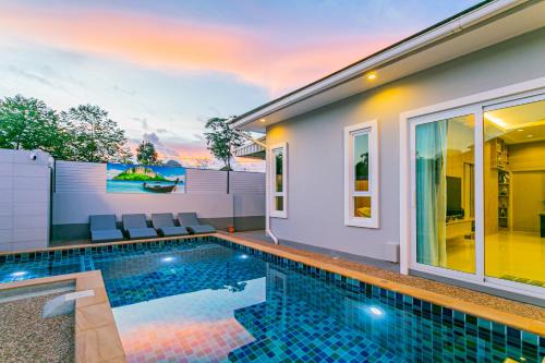 a swimming pool in the backyard of a house at "Smooth as Silk" Gorgeous 3-Bedroom Pool Villa, Just a Stone's Throw from the Beach! in Ban Khlong Haeng