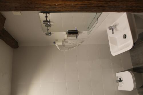 a bathroom with a sink and a urinal and a toilet at Pensión Manoli in Bilbao