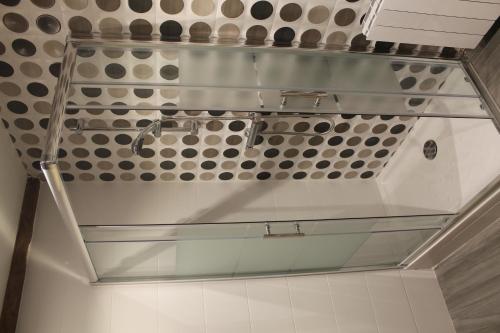 a bathroom with a sink and a glass shelf at Pensión Manoli in Bilbao