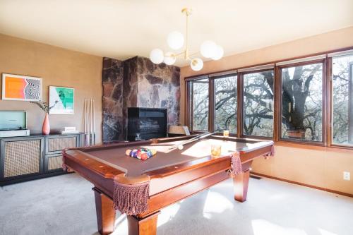 a pool table in a living room with a tv at Gable by AvantStay Beautiful 3.5 Acre Oasis w Gorgeous Views Pool Hot Tub in Santa Rosa